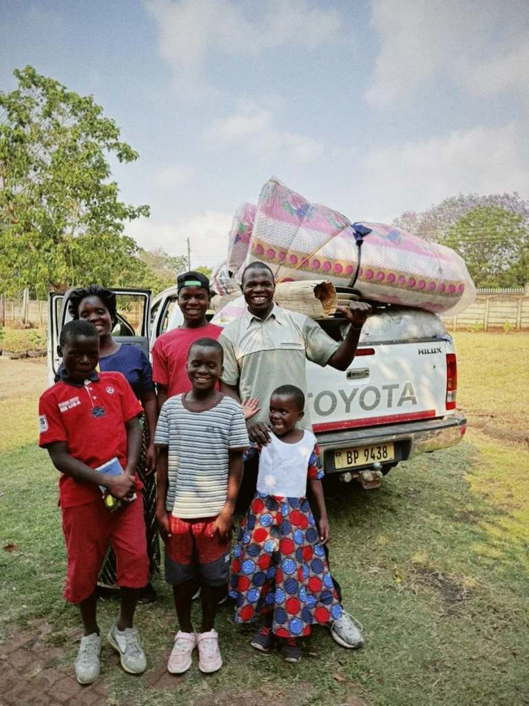 Family in front of a car