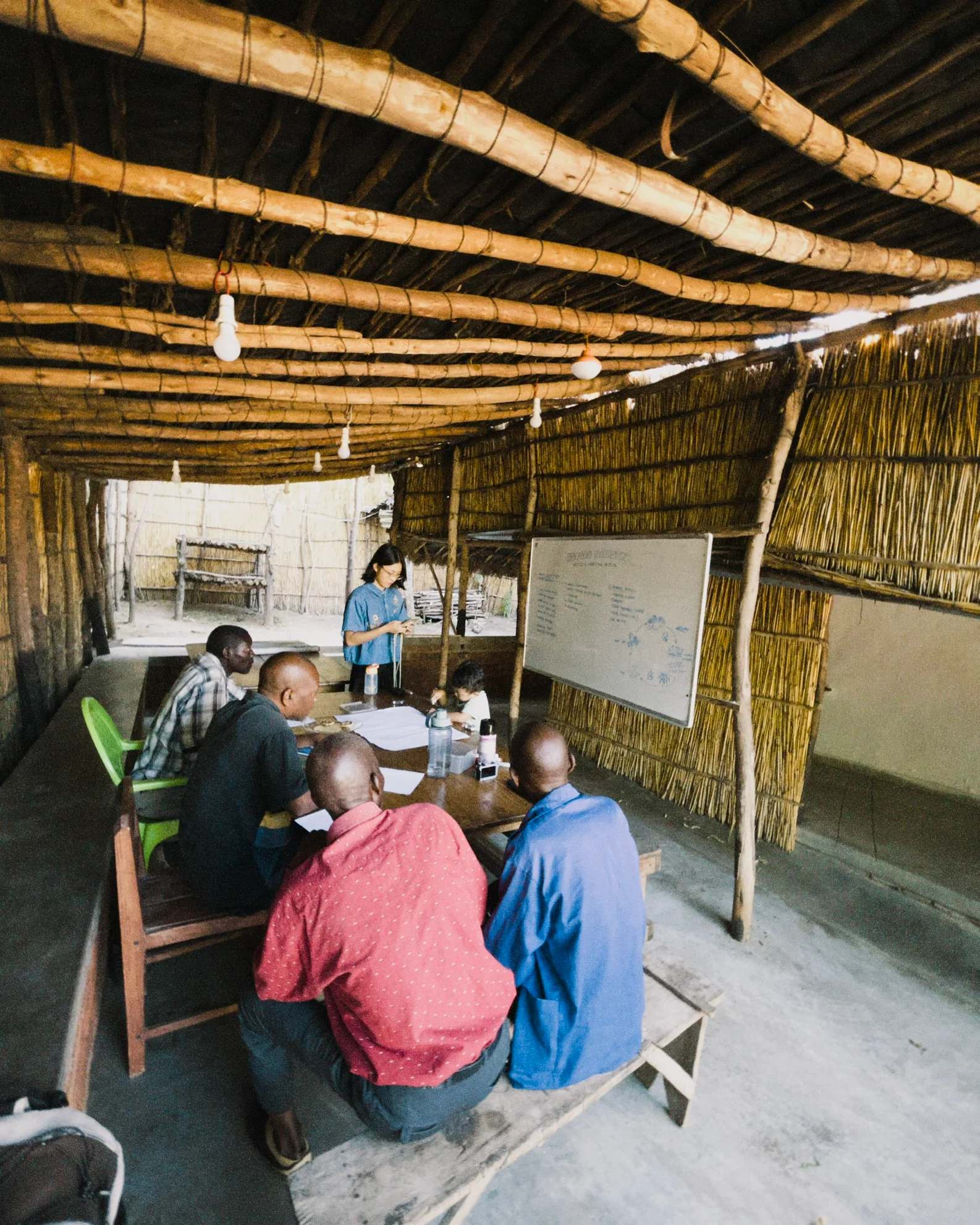 People sitting looking at a whiteboard.